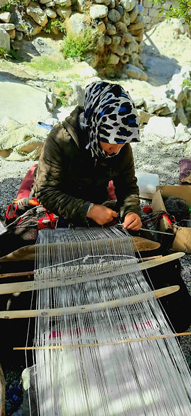 women are weaving and repairing the navy blue fishing nets - DR