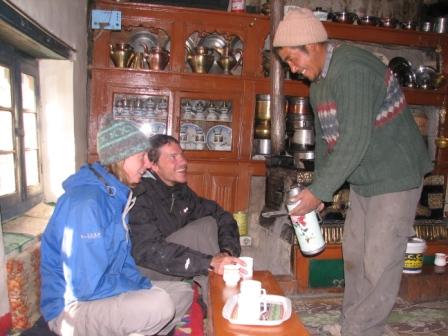 A host serves tea to a guest in a homestay